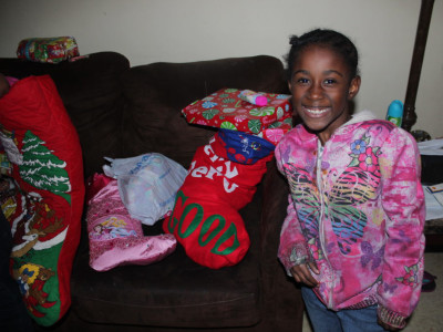 Smiling girl who just got her Christmas stocking | Stockings of Love | Mercy Missions