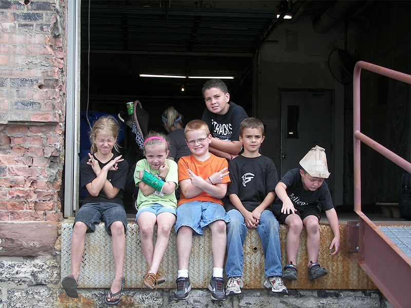 kids sitting and posing in loading dock