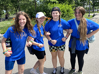 4 girls posing with locked arms at Niagara Falls