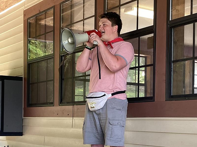Sam speaking through a megaphone