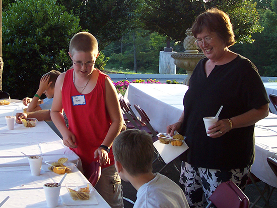 Sylvia Brown helping a child with snack
